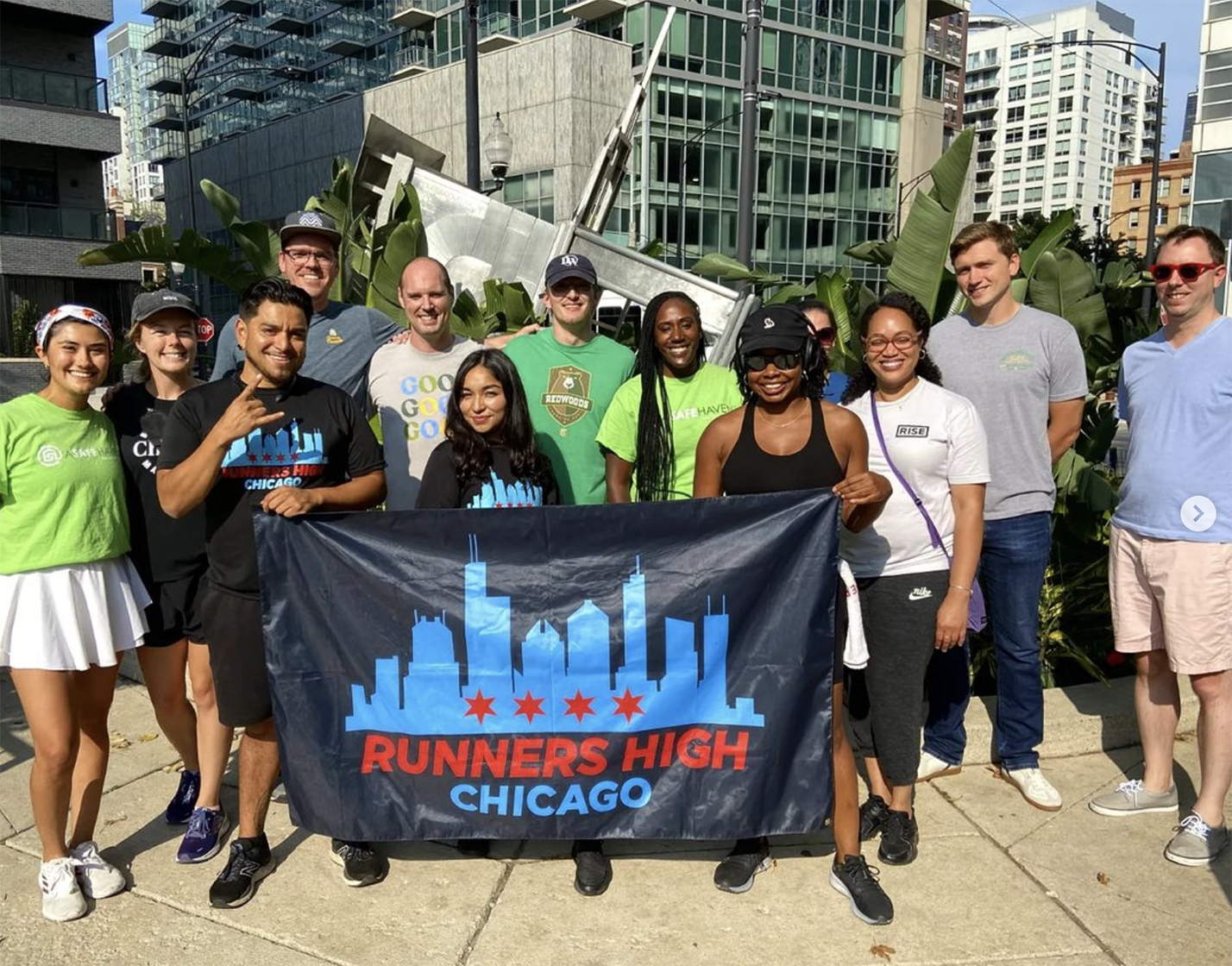 Photo of Green Thumb team outdoors in Chicago, holding banner that reads, "Runnings High Chicago"